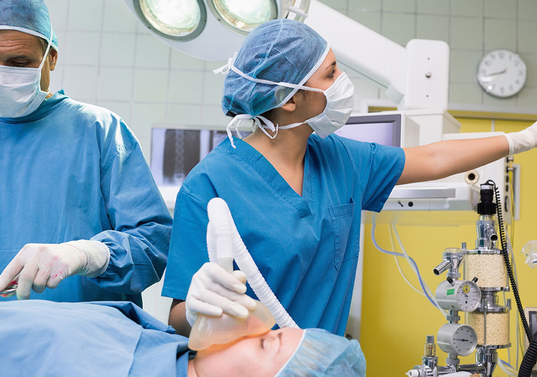 Anesthesiologist and surgical nurse preparing for a hospital-based procedure in Dallas, TX